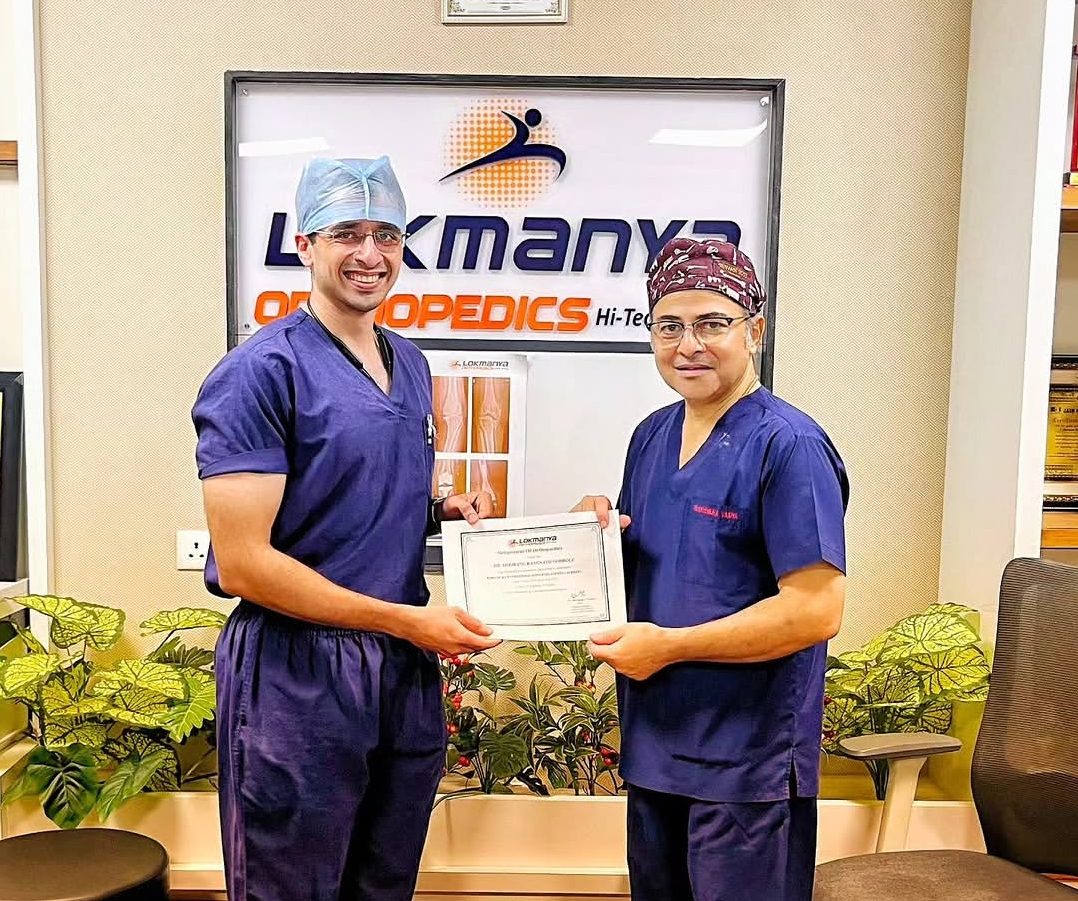 Dr. Godbole receiving his MUHS fellowship completion certificate from Dr. Narendra Vaidya