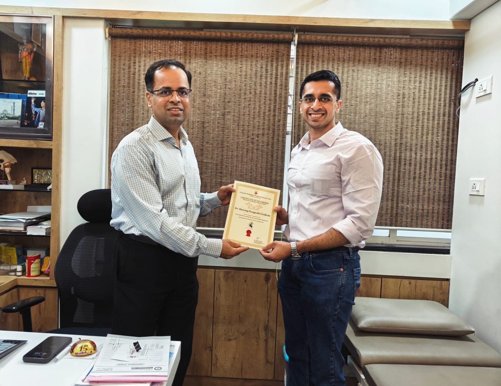 Dr. Godbole receiving his FIAS fellowship completion certificate from Dr. Shirish Pathak